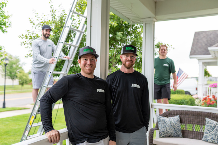 K-Guard team members smiling in front of their work