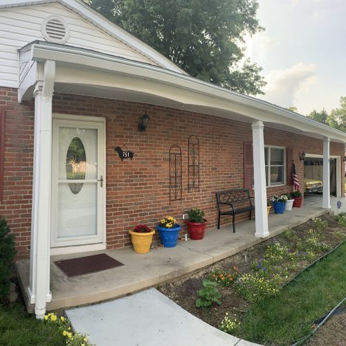 front porch of brick and white house