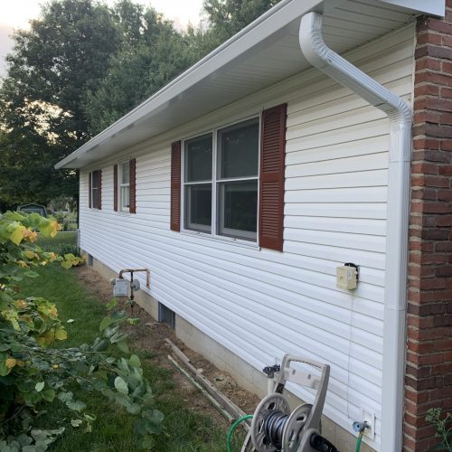 white house maroon shutters downspout and gutters