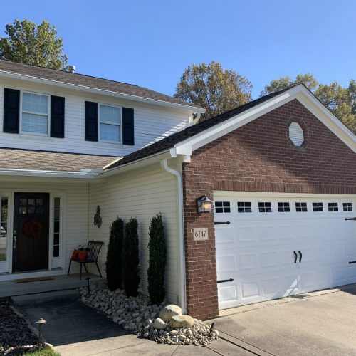 front view of white & brick residence