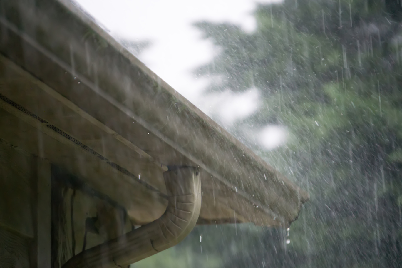 Rain dripping down seamless gutter system